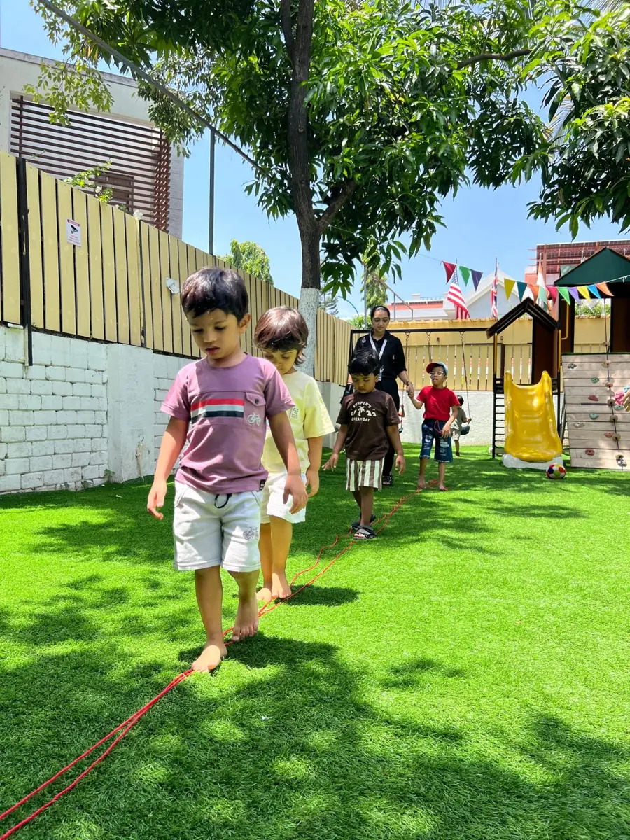 Children walking a balance line outdoors