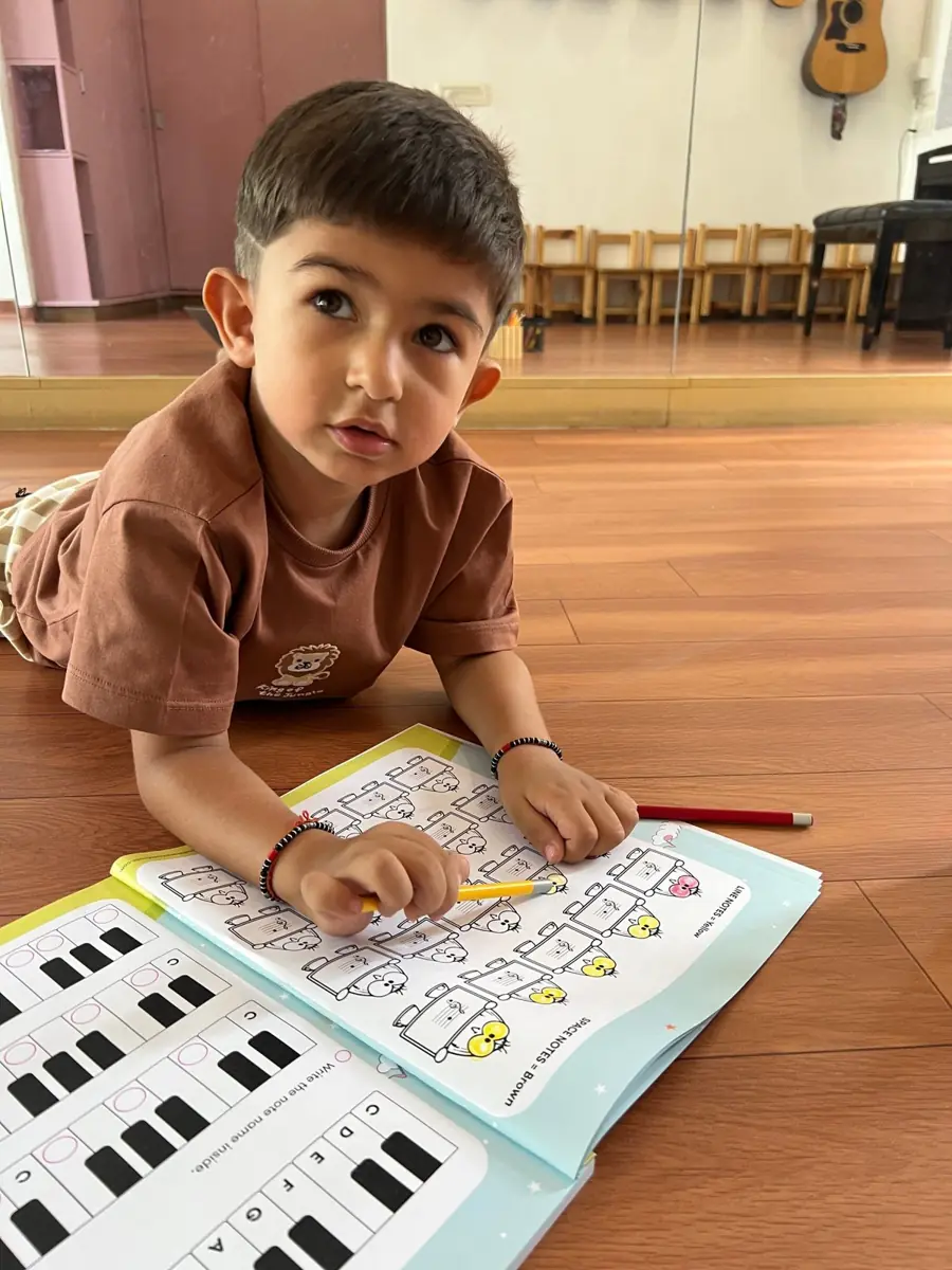 A boy reading music notes in his workbook
