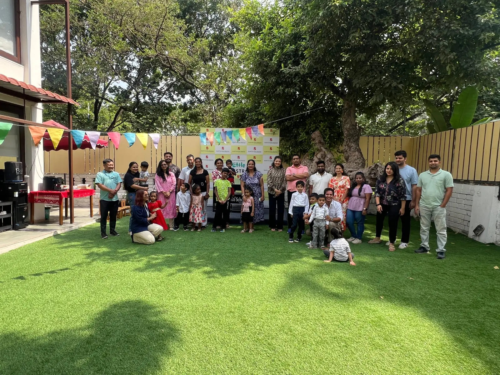 Families and children at a BodhiTree Little Maestros celebration in the garden